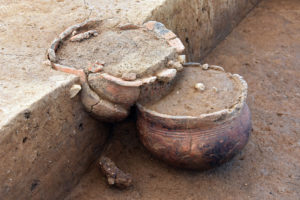 Détail de deux vases déposés sur deux niveaux au sein de la même sépulture. Le récipient à la base comporte un décor de quatre cannelures